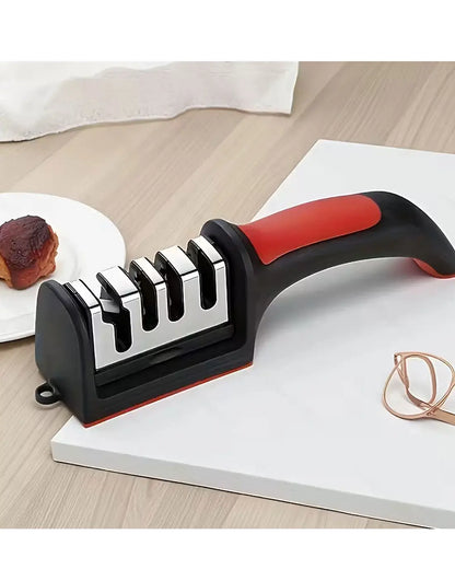 Knife sharpener with red handle on a white surface